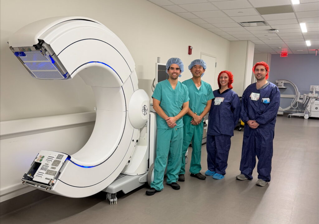 Dr. Daniel E. Choi (center) and Dr. Justin B. Ledesma (left) with the O-arm™ Imaging System at Good Samaritan University Hospital in West Islip, N.Y. Dr. Choi was the first surgeon to utilize the system at the hospital during a minimally invasive navigated TLIF procedure on February 23, 2026.